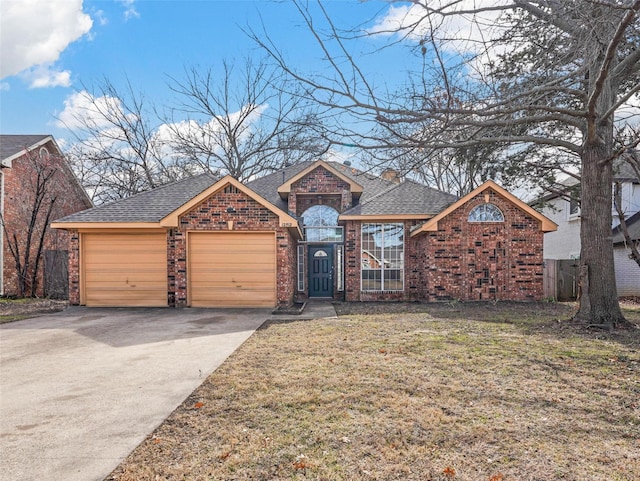 view of front of house featuring a garage and a front lawn