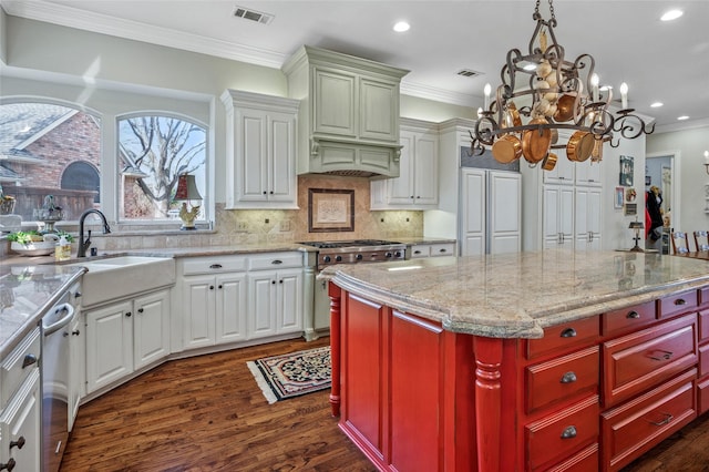 kitchen with white cabinetry, crown molding, sink, and high end range