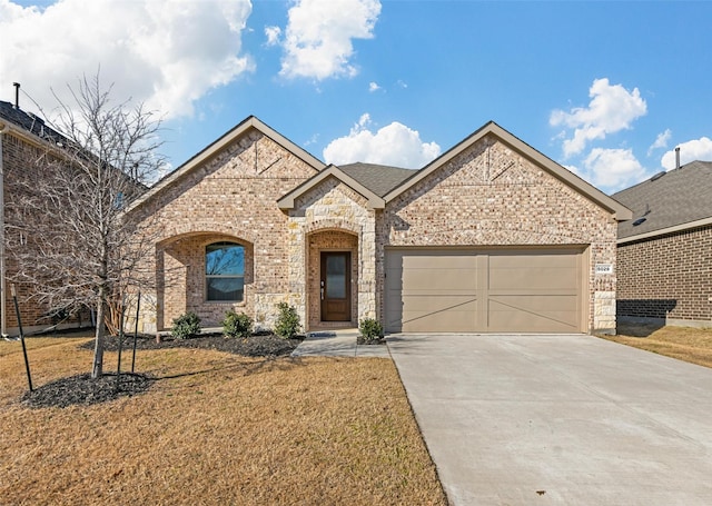 view of front of property featuring a garage and a front yard