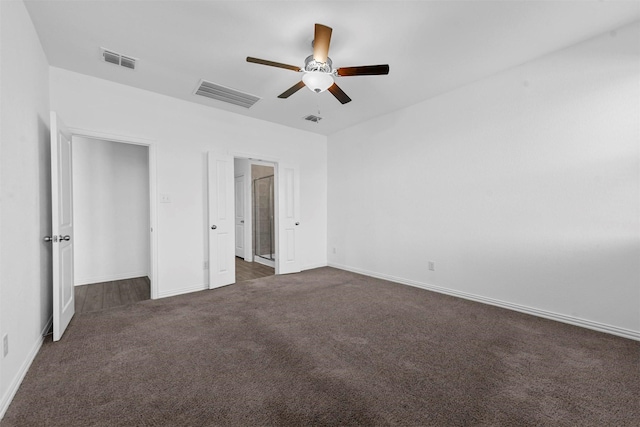 unfurnished bedroom with ceiling fan and dark colored carpet