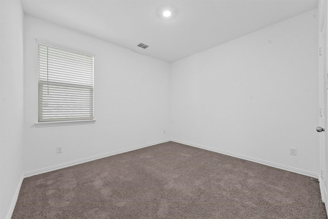 empty room featuring dark carpet