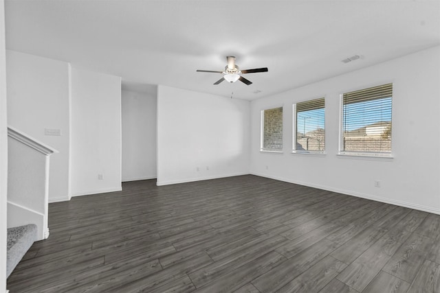 empty room with dark hardwood / wood-style floors and ceiling fan