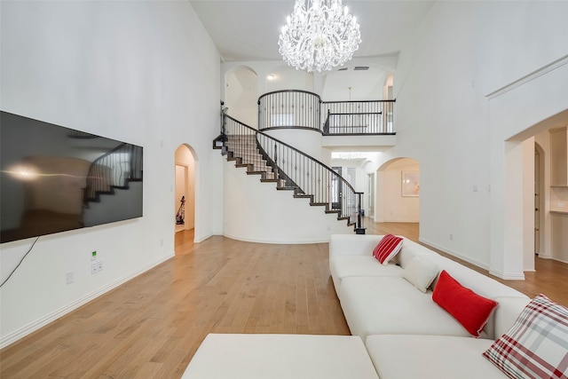 509 Christie Xing, Celina, TX 75009 - living room with an inviting chandelier, light hardwood / wood-style floors, and a high ceiling