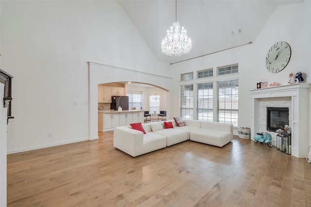 509 Christie Xing, Celina, TX 75009 - living room featuring an inviting chandelier, light hardwood / wood-style flooring, and a high ceiling