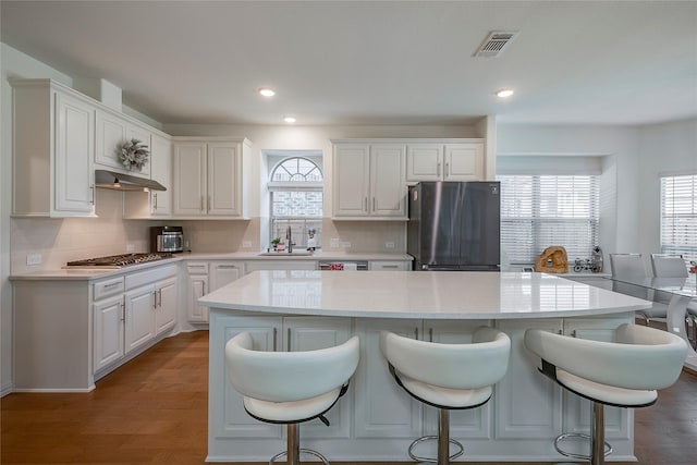 509 Christie Xing, Celina, TX 75009 - kitchen with a kitchen island, appliances with stainless steel finishes, sink, and white cabinets