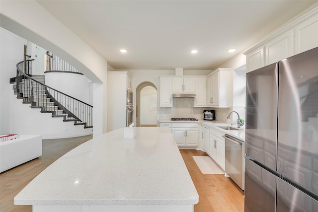 509 Christie Xing, Celina, TX 75009 - kitchen with white cabinetry, appliances with stainless steel finishes, a center island, and sink