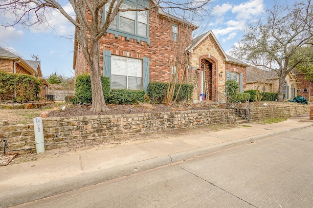 view of front of property with brick siding and stone siding