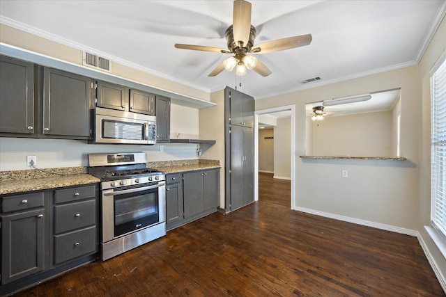 kitchen with stainless steel appliances, ornamental molding, light stone countertops, and dark hardwood / wood-style floors