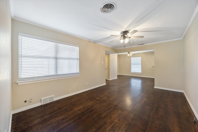 unfurnished room featuring crown molding, plenty of natural light, and dark hardwood / wood-style flooring