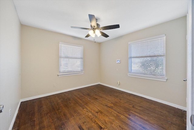 spare room featuring ceiling fan and dark hardwood / wood-style floors