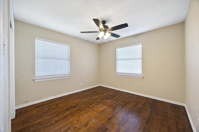 spare room featuring dark hardwood / wood-style floors and ceiling fan