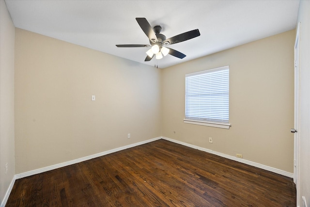 spare room with dark hardwood / wood-style floors and ceiling fan