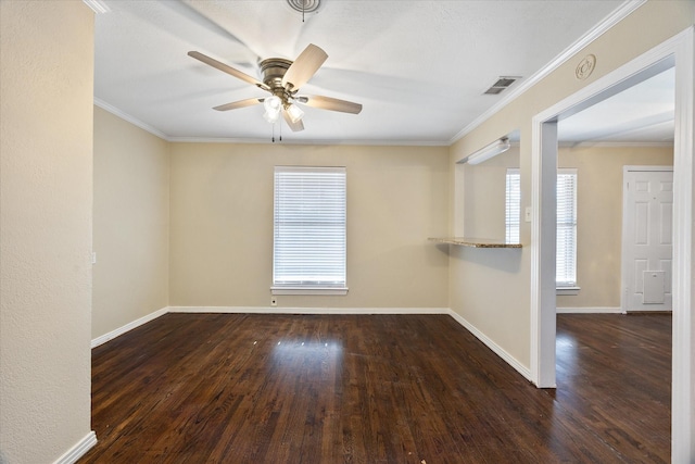 spare room featuring dark wood-type flooring, ceiling fan, and crown molding