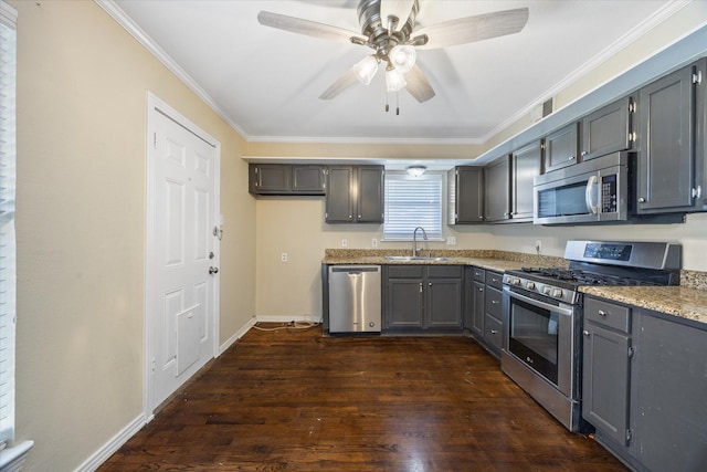 kitchen with stainless steel appliances, ornamental molding, sink, and gray cabinets