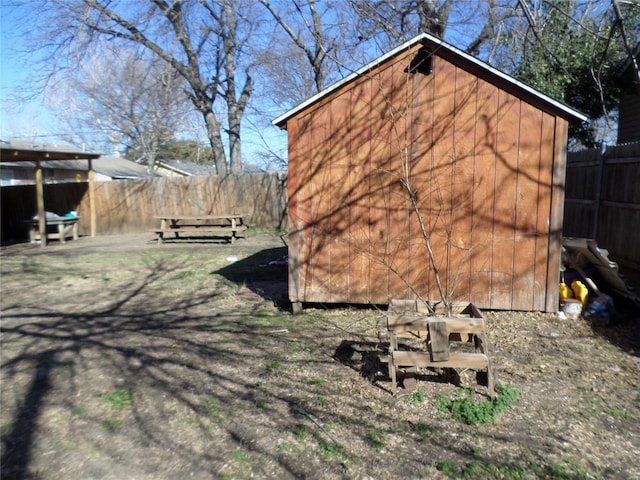 view of side of home with a shed