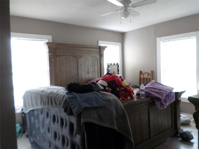 bedroom with multiple windows and ceiling fan