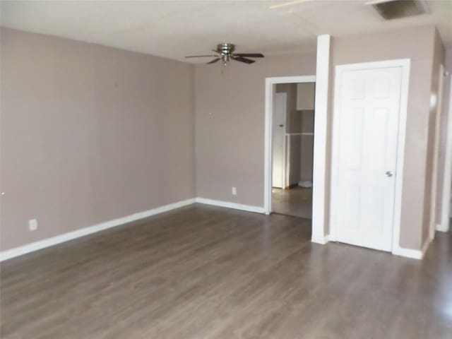 empty room with ceiling fan and dark hardwood / wood-style floors