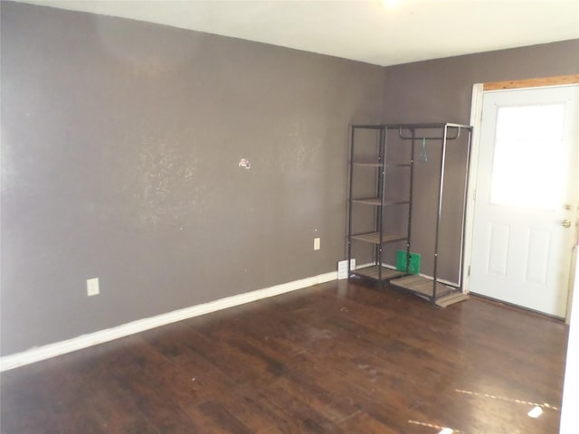 spare room with dark hardwood / wood-style floors