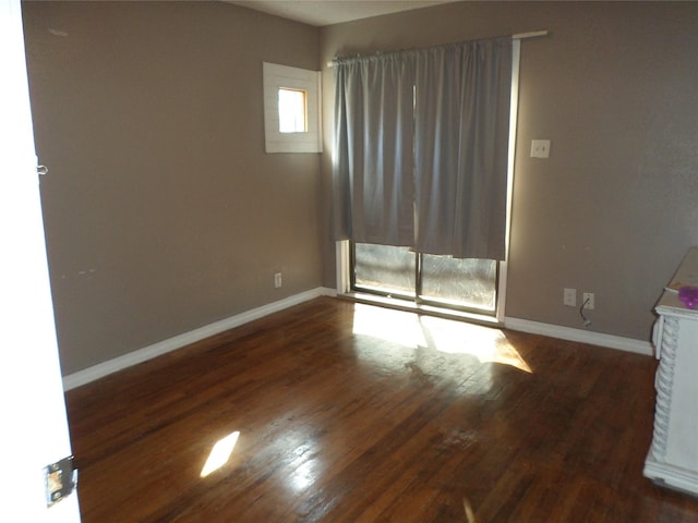 empty room featuring dark hardwood / wood-style flooring