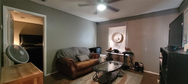 sitting room with dark hardwood / wood-style flooring and ceiling fan