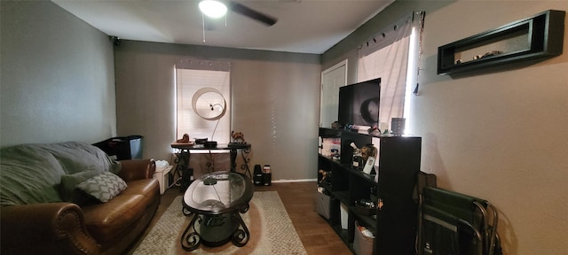 living room with dark hardwood / wood-style flooring and ceiling fan