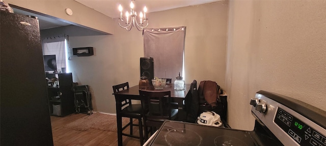 dining space featuring a notable chandelier and hardwood / wood-style flooring