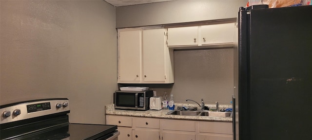 kitchen featuring stainless steel appliances, sink, and white cabinets