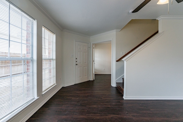 entrance foyer featuring dark wood finished floors, crown molding, ceiling fan, baseboards, and stairs