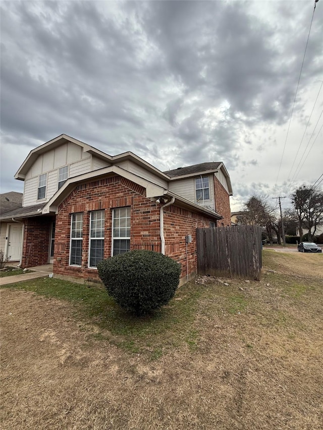 view of side of home with a lawn