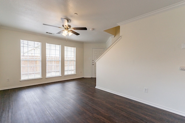 unfurnished living room with dark wood-type flooring, a ceiling fan, baseboards, visible vents, and crown molding