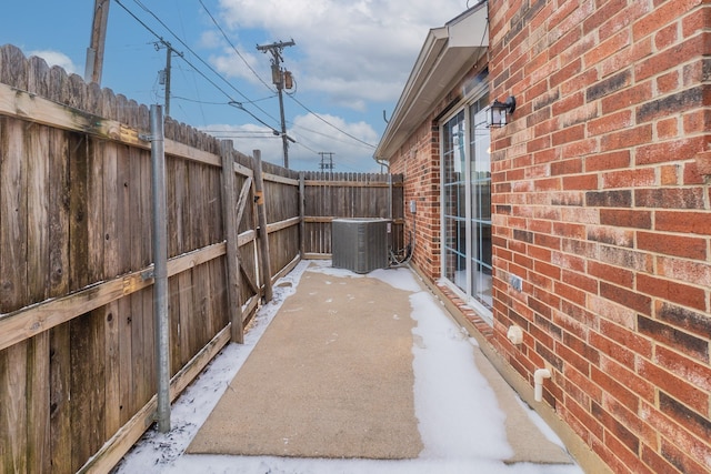 view of patio with a fenced backyard and central AC unit