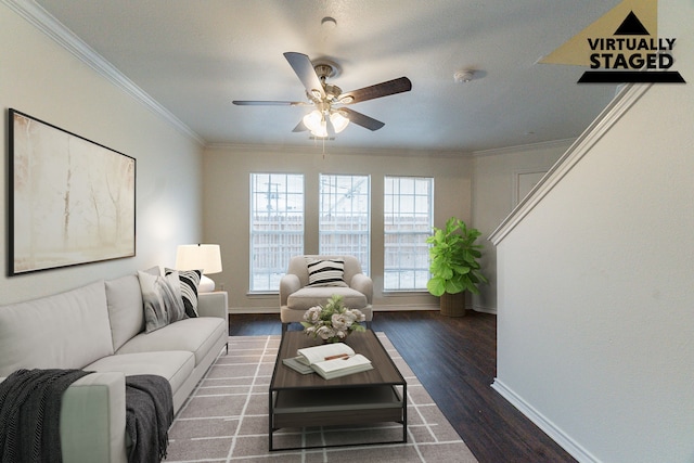 living room featuring ceiling fan, baseboards, ornamental molding, and dark wood finished floors