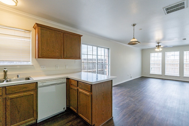 kitchen featuring a sink, visible vents, light countertops, and dishwasher