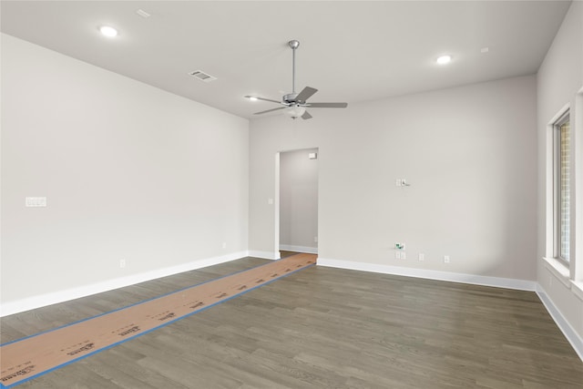 unfurnished room with baseboards, visible vents, ceiling fan, and wood finished floors