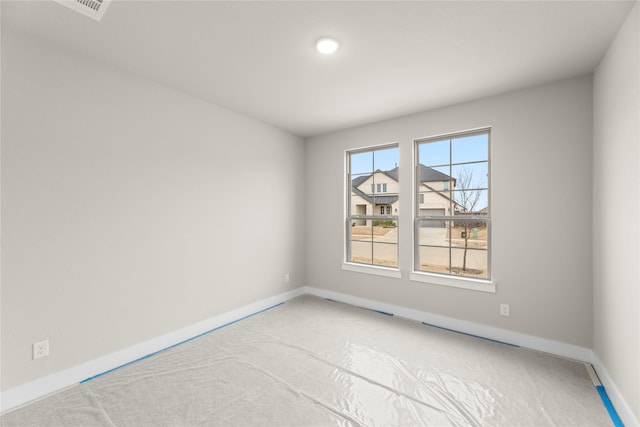 carpeted empty room with baseboards