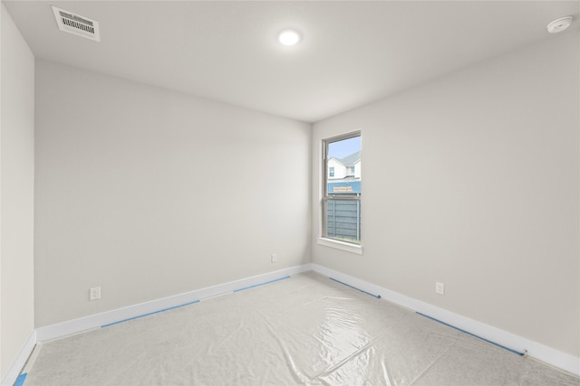 spare room with baseboards and visible vents