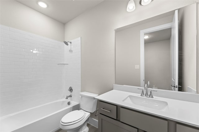 bathroom featuring toilet, bathtub / shower combination, and vanity