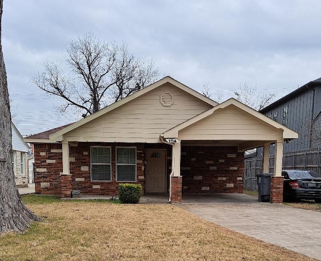 view of front of property with a carport and a front yard