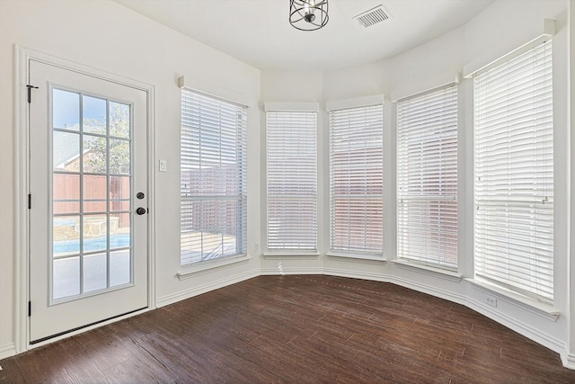 unfurnished dining area with dark hardwood / wood-style floors