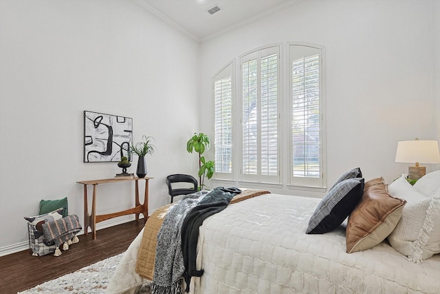 bedroom with dark wood-type flooring, ornamental molding, and multiple windows