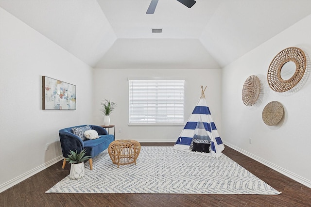 sitting room with lofted ceiling, dark hardwood / wood-style flooring, and ceiling fan