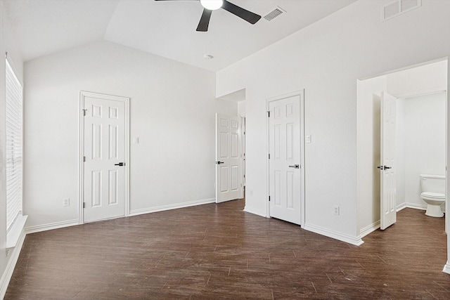 unfurnished bedroom with dark wood-type flooring, ceiling fan, ensuite bathroom, and lofted ceiling