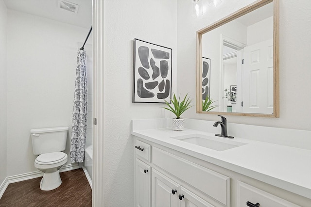 full bathroom with hardwood / wood-style flooring, vanity, toilet, and shower / bath combination with curtain