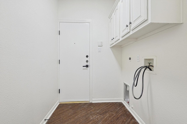 clothes washing area featuring gas dryer hookup, cabinets, hookup for a washing machine, dark wood-type flooring, and hookup for an electric dryer