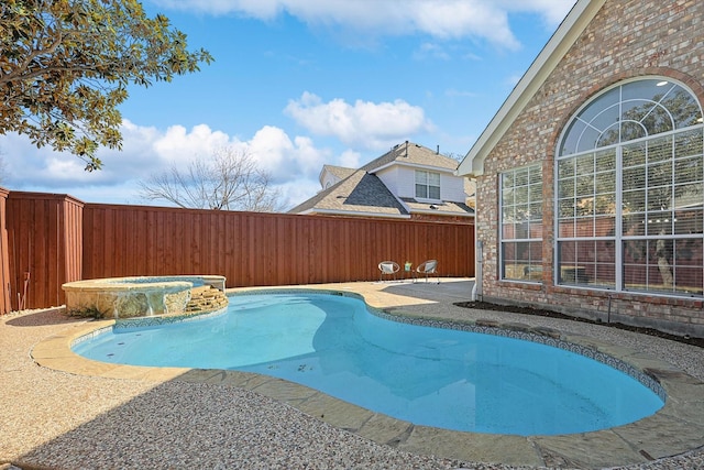 view of swimming pool with an in ground hot tub and a patio area