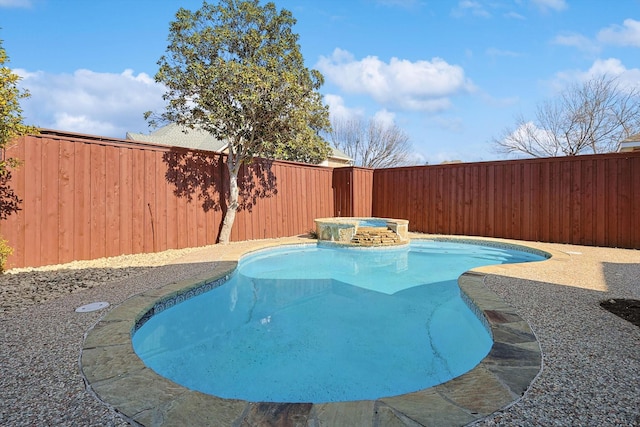 view of swimming pool featuring an in ground hot tub