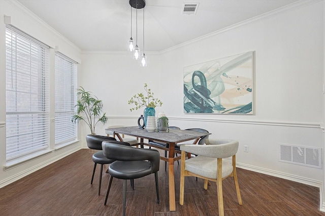 dining space with crown molding and dark wood-type flooring