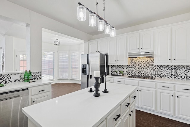 kitchen featuring a kitchen island, dark hardwood / wood-style floors, white cabinets, hanging light fixtures, and stainless steel appliances