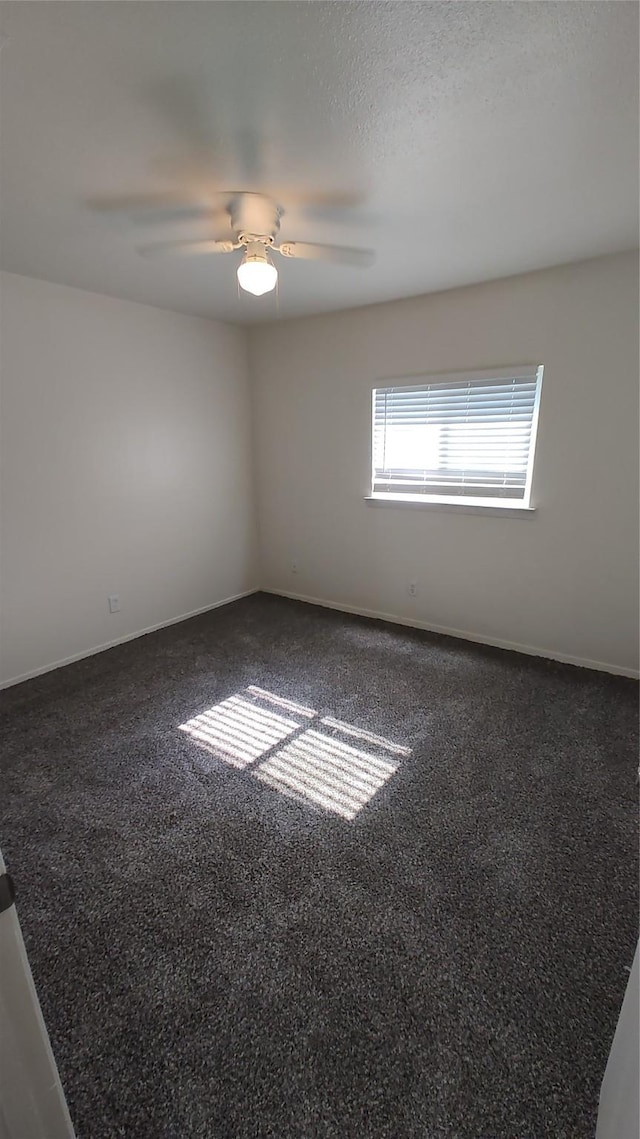 unfurnished room featuring a textured ceiling, carpet floors, and ceiling fan