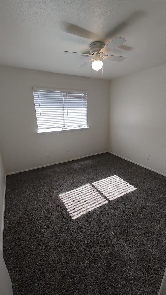 carpeted empty room featuring a textured ceiling and ceiling fan